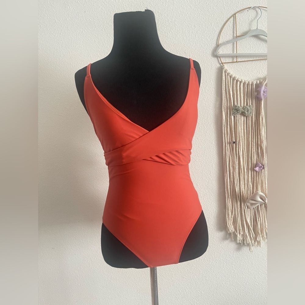 Strapless orange one-piece swimsuit.